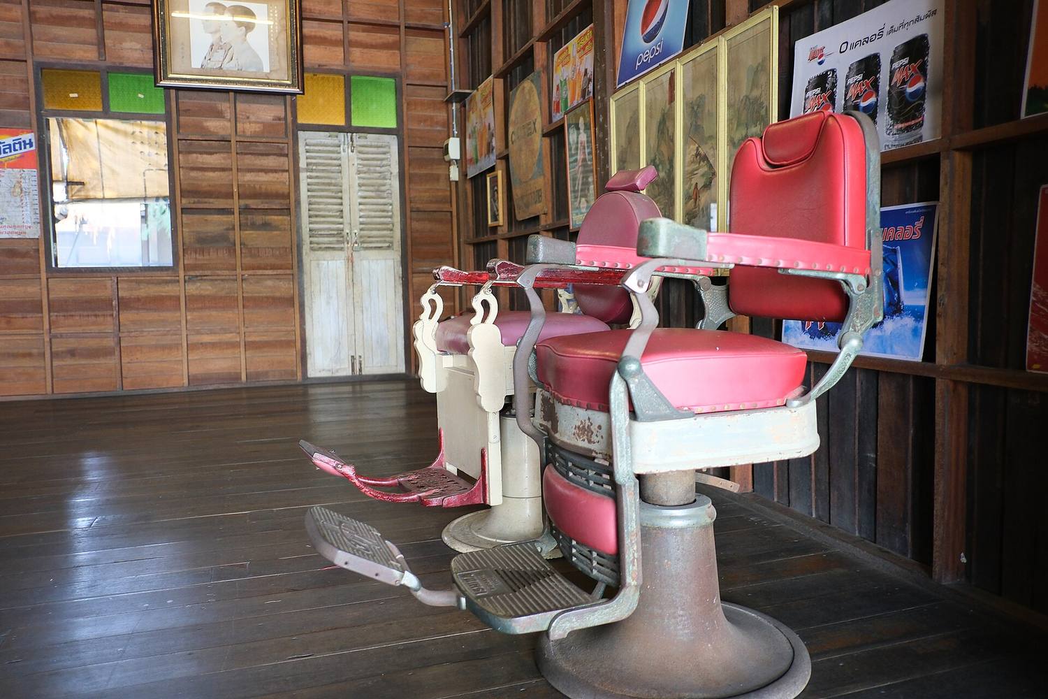 A classic red barber chair in a wood-paneled shop