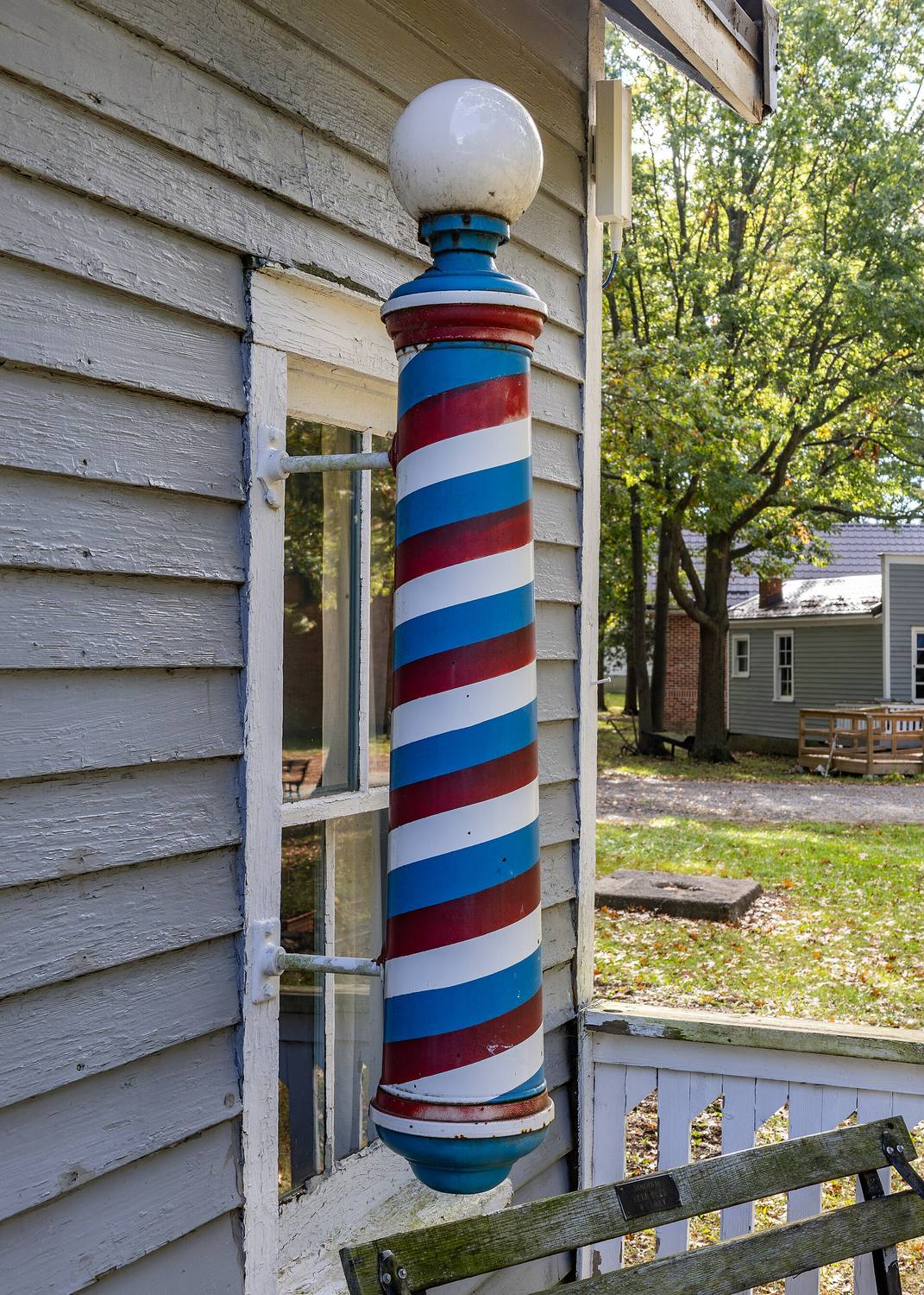 A red, white and blue barber pole outside a shop