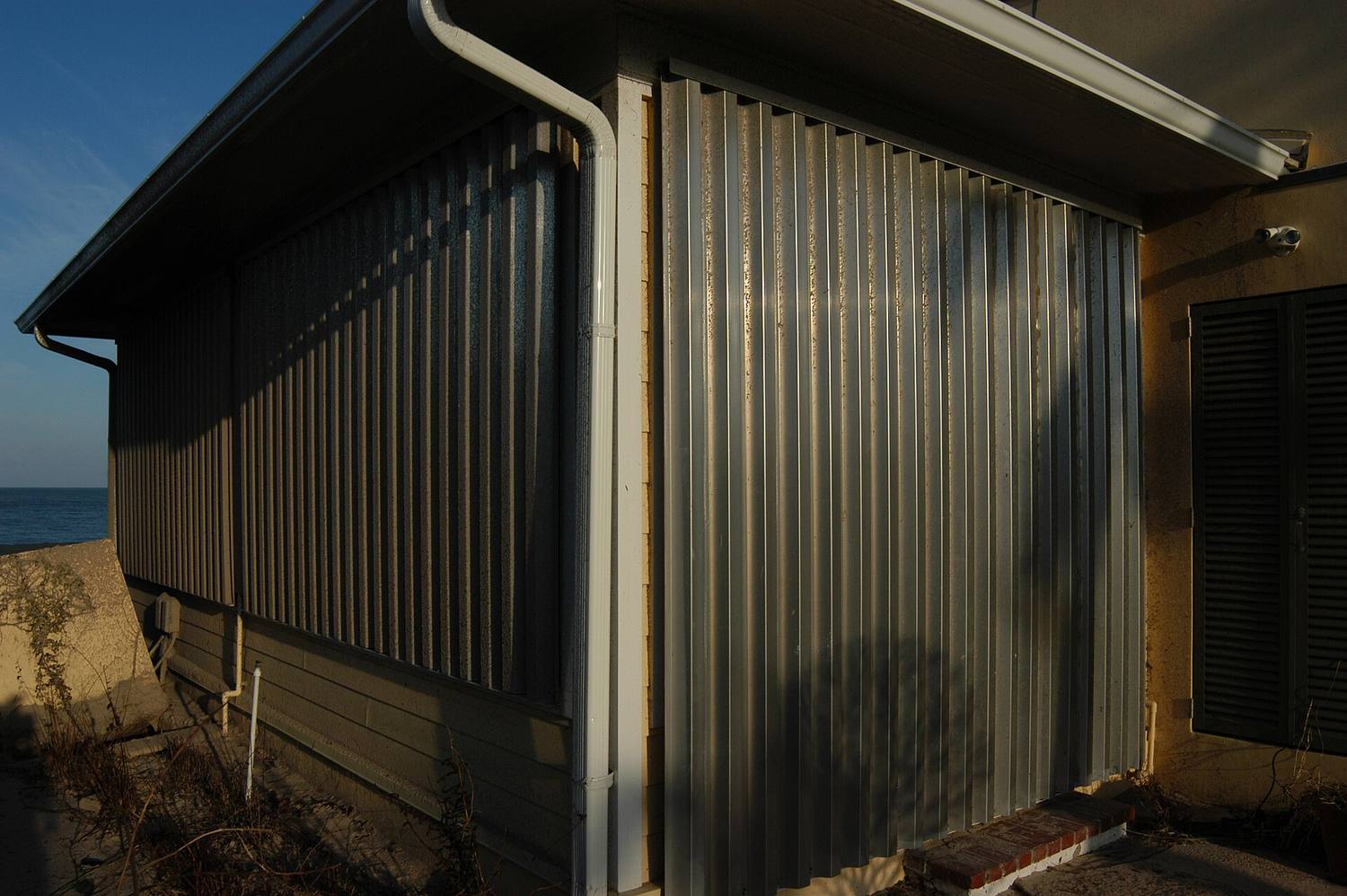 A house with metal hurricane shutters closed