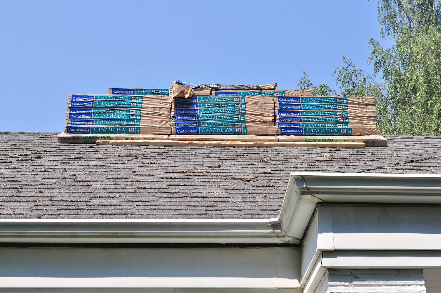 Bundles of new shingles staged on a roof during a re-roof