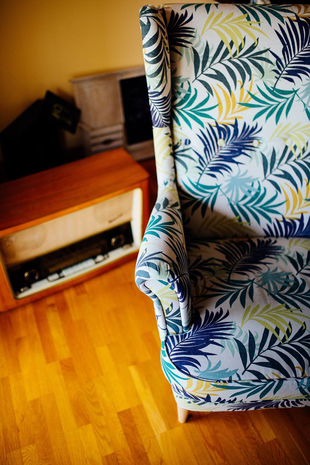 A comfortable patterned armchair by a window