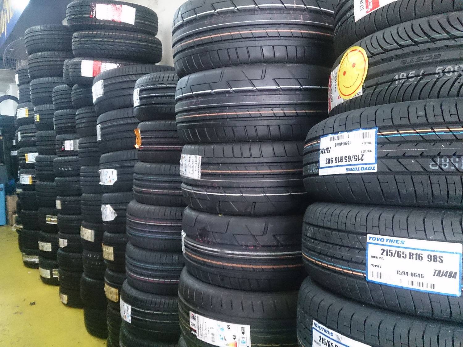 Tall stacks of new tires in a tire shop